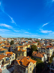 Fototapeta premium City view with houses and blue sky over rooftops in a residential area during daytime