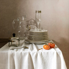 Clean washed dishes on a table with a tablecloth.