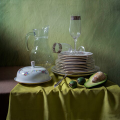 Clean washed dishes on a table with a tablecloth.