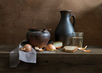 A village dinner in a clay pot with milk, bread, salt and onions.