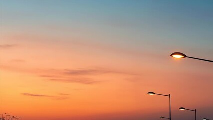 Street lamps silhouette against the gradient morning light sky showing a serene urban landscape at dawn - Powered by Adobe
