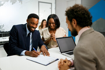 Business people signing contract during a meeting at office