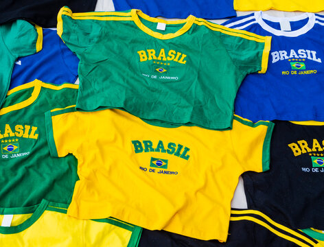 Street stall displaying colorful brazilian national football team t-shirts, celebrating the iconic selecao