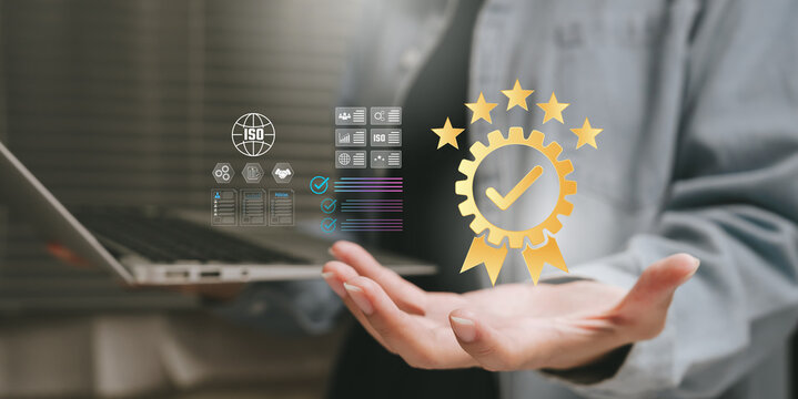 Quality assurance concept, hand presenting certification badge with ISO icons and approval checkmark, compliance standards, process control, business excellence, trust and credibility