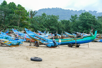 Traditional wooden fishing boats line Rajegwesi Beach, Banyuwangi, as fishermen prepare to head out to sea, capturing coastal livelihoods, maritime traditions, and daily life on Java&rsquo;s southern coast.