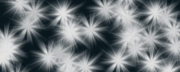 Fototapeta premium Glowing white starburst flares on dark blue background with film grain, celestial light effect or holiday sparkle illustration.
