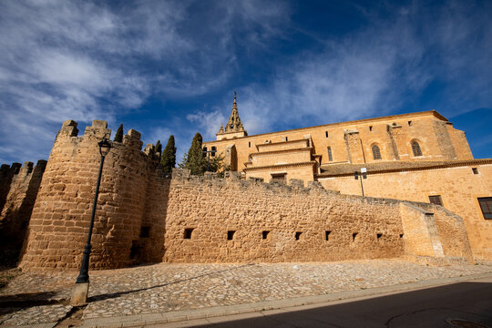 Basilica of Our Lady of the Assumption with the castle wall in Villanueva de la Jara, Cuenca, Spain