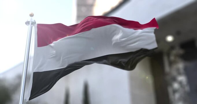 Yemen National Flag Waving in Slow Motion with Warm Sun Flare Background