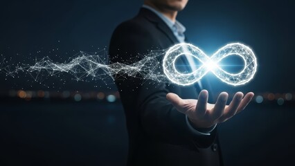 Professional holding a glowing digital infinity symbol representing boundless possibilities innovative solutions and continuous data flow in a dark setting.