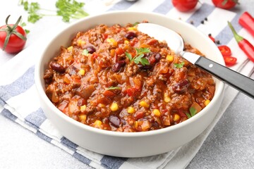 Delicious chili con carne served on table, closeup