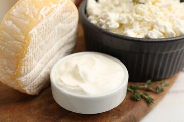 Different dairy products and thyme on table, closeup