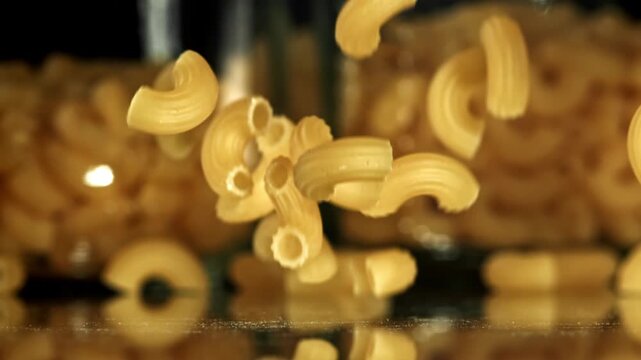 Super slow motion dry macaroni pasta . Filmed on a high-speed camera at 1000 fps. High quality FullHD footage