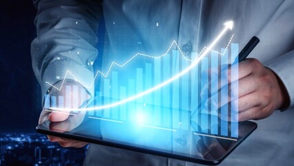 A business professional utilizes a tablet to analyze financial data, showcasing growth trends and charts against a vibrant night city backdrop, symbolizing progress. Copula