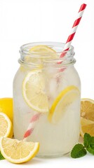 Fototapeta premium Refreshing lemonade in a mason jar with lemon slices and straw