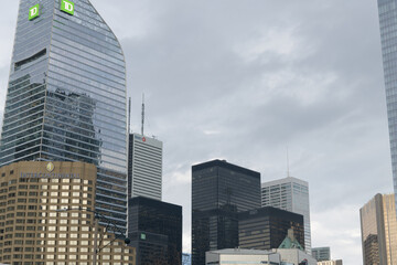 Naklejka premium (at left) TD Terrace, a corporate office, and financial district skyline with overcast sky, viewed from Roundhouse Park, Toronto