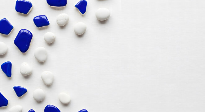 Smooth white pebbles and shiny cobalt blue sea glass pieces scat