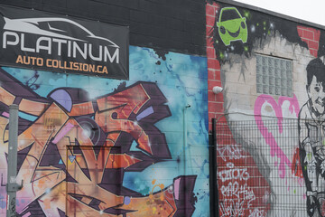 Naklejka premium street art at the rear of Platinum Auto Collision, an auto body and collision repair shop located at 2 Cariboo Av in Toronto (shown from Junction Triangle / West Toronto rail area)