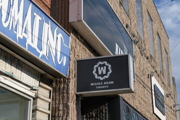 Naklejka premium projecting wall sign outside Wiggle Room, Toronto, a late‑night live music, dance and cultural venue at 772 Dundas St W, near Bathurst St