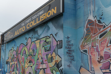 Naklejka premium exterior wall with street art and sign of Platinum Auto Collision located at 2 Cariboo Av, Toronto (shown here side facing Osler St)