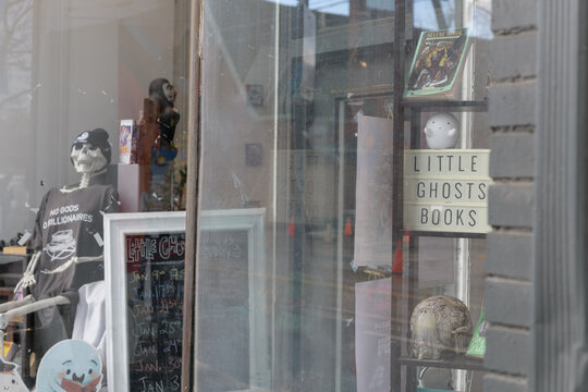 display window with merchandise at Little Ghosts Books located at 930 Dundas St W, Toronto