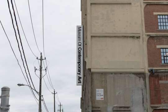 exterior projecting sign outside The Museum of Contemporary Art Toronto Canada (MOCA), located at 158 Sterling Rd, a repurposed former automobile manufacturing building