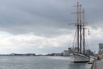 Naklejka premium Empire Sandy, a historic 200-foot three-masted schooner based in Toronto, originally built in 1943 as a British WWII deep-sea tugboat, later converted in the 1980s into a sail-rigged passenger ship