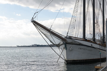 Naklejka premium Empire Sandy, a historic 200-foot three-masted schooner based in Toronto, originally built in 1943 as a British WWII deep-sea tugboat, later converted in the 1980s into a sail-rigged passenger ship