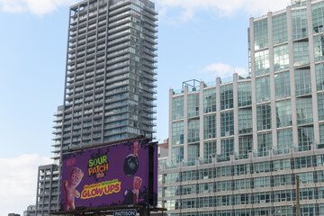 Obraz premium traditional roadside billboard for novelty sour gummies that fluoresce under UV/blacklight, a visual twist on classic Sour Patch Kids, Toronto