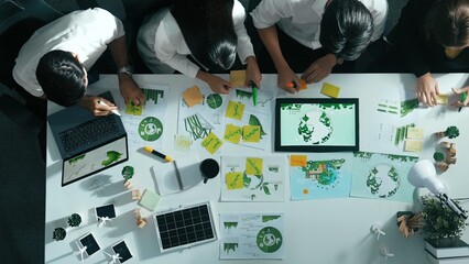 Top view of executive manager hold tablet display clean energy at meeting. Aerial view of business people working together to plan and invest in sustainable environmental investment. Alimentation.