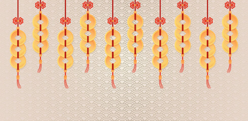 Traditional Chinese lucky charms featuring golden coin-like ornaments strung together with red knots and tassels on a patterned background.