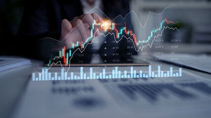A professional examines digital stock market data with modern graphs and charts, illustrating the...