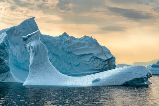 A group of icebergs in Uummannaq fjord in west Greenland during sunny day in the summer