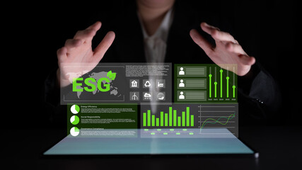A business professional uses innovative technology to explore and analyze ESG data metrics, showcasing the importance of sustainable and responsible investment approaches. Gantry