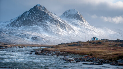 Remote Arctic House on Tundra Riverbank with Mountain Peaks