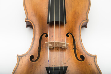 Violin close-up with bridge, strings and f-holes, classical string instrument detail isolated on white background