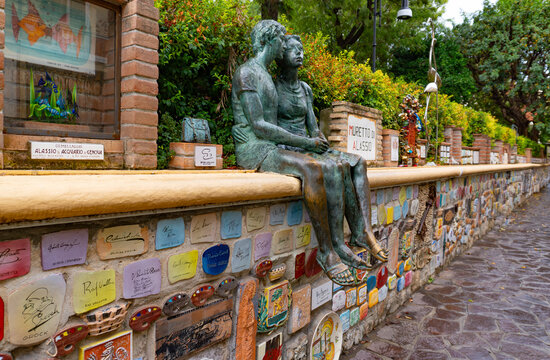 Alassio, Savona, Liguria, Italy - August 20, 2025: Alassio's Wall, the famous wall with the bronze statue of the lovers