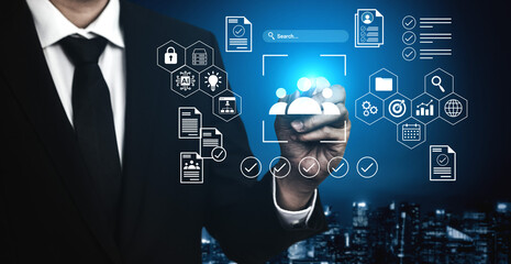 A businessman engages with a digital interface filled with data analytics and icons, showcasing the intersection of technology and business strategy in an urban nightscape. Gantry