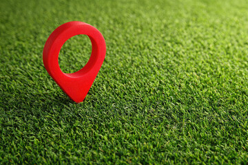 Location pin icon on green earth or green field Land for home concept. A big red map pointer symbol on green field 