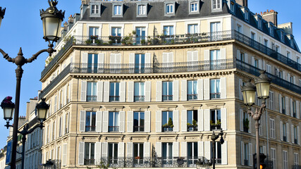 Stately Parisian Apartment Building with City Streetlamps in Foreground