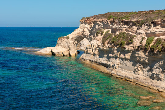 Munxar Window picturesque natural rock arch in Marsascala, Malta. Popular spot for swimming, kayaking, and enjoying scenic views at Mediterranean Sea