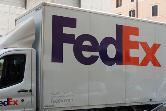 Rome, Italy, Europe - Dec 19, 2025: Fedex delivery truck vehicle logistics transport on rome street white van with purple and orange logo concept of shipping, courier services, global trade
