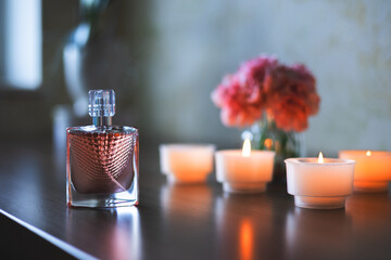Women's perfume and candles. Luxurious atmosphere.