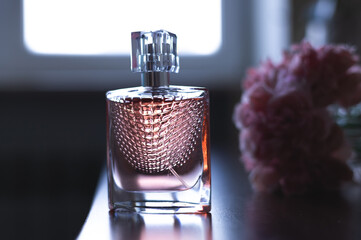Women's pink perfume and flowers