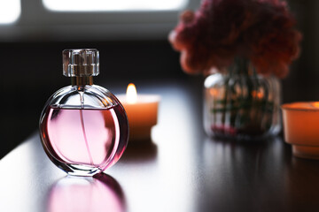 Women's perfume and candles. Luxurious atmosphere.