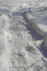 path in white snow on a winter day.