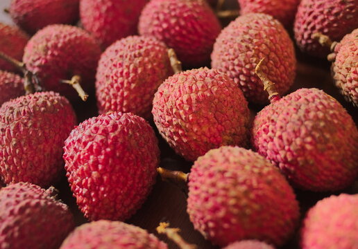 Ripe lychee fruits on a surface. Close-up. Scientific name Litchi chinensis Sonn, also known as lychee and alexia.