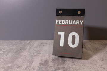 February 10 displayed on wooden blocks, symbolizing the date.