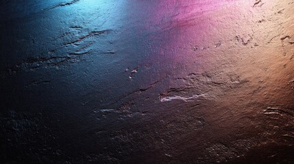 Textured dark surface with vibrant lighting colors creating a modern artistic atmosphere suitable for backgrounds and abstract designs.