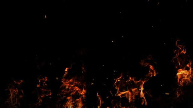 Floating fire embers and subtle flame elements on black background for cinematic overlays, dramatic transitions and motion graphics effects
