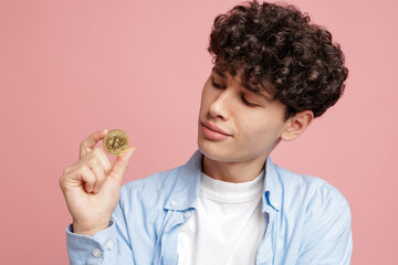 Young man examining crypto coin digital currency investment and blockchain finance concept
